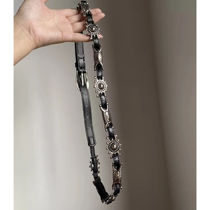 Close-up of bohemian black leather belt with silver vintage metal buckles and studs