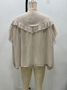 Detailed rear view of beige chiffon shirt with stylish layered ruffle decorations