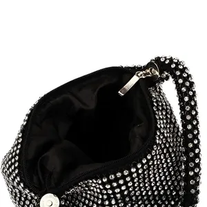 Detailed close-up of sparkling silver rhinestones, black fabric lining, and secure zipper