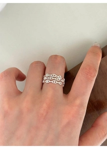 Detail of three-layer sterling silver anchor link ring shown on a finger