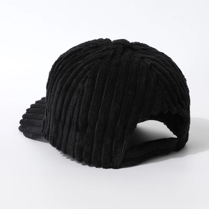 Detail of the black corduroy baseball cap showing thick ribbed texture and rear closure