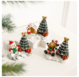 Detailed view of resin Christmas miniatures set with snowman, Santa, and reindeer figures