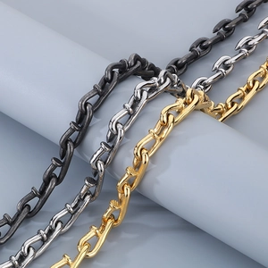 Close-up of titanium steel nail link chains in black, silver, and gold finishes