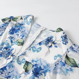 Detail of floral print dress with blue butterfly pattern and high-quality back zipper closure