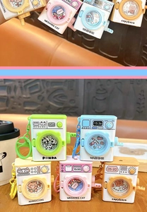 Detail showing colorful washing machine keychains with cartoon panda and cat designs