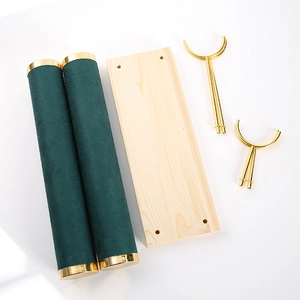 Disassembled parts of luxury wood jewelry display showing velvet rolls and gold metal stands