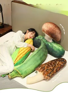 Realistic vegetable plush pillows in corn and mushroom shapes shown on a cozy bed