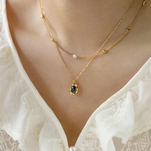 Double-layered 18K gold plated pearl necklace with black oval gemstone pendant