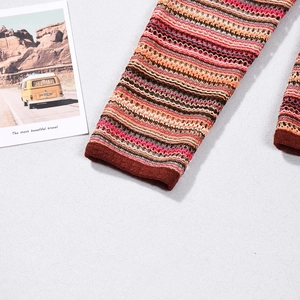 Detail of colorful striped knit fabric with openwork mesh texture in warm earthy tones
