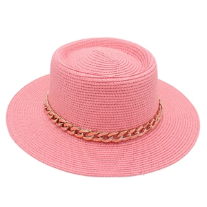 Detailed view of a pink straw boater hat featuring a decorative gold acrylic chain strap.