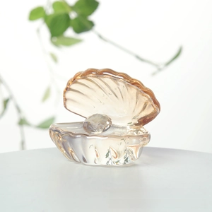 Macro detail of amber crystal shell ornament featuring a faceted crystal pearl inside