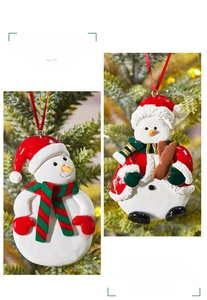 Detailed view of handmade snowman Christmas tree ornaments with festive red ribbons