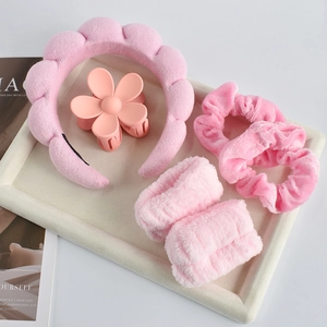 Detailed view of 6-piece pink hair accessory set with soft headband and matte flower clip