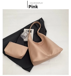 Detail view of pink pebbled leather tote bag with a matching small zipper pouch