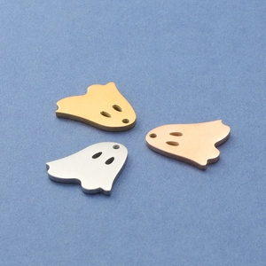 Ghost ghost pendants in gold, silver, and rose gold finishes on a blue background