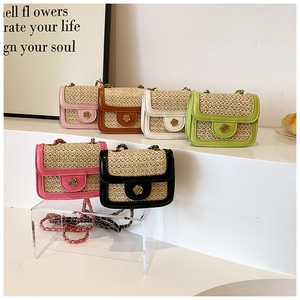 Detailed close-up of colorful mini straw bags with flower buckles and gold chain straps