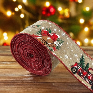Detailed view of linen Christmas ribbon with festive truck and snowflake patterns on wood