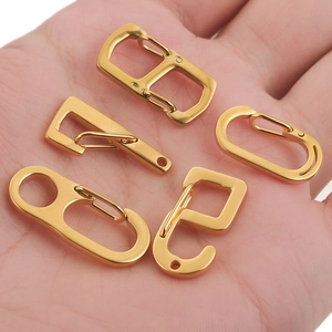 Polished gold stainless steel lobster clasps and DIY jewelry hooks held in palm