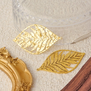 Two gold 304 stainless steel leaf pendants with textured design for DIY jewelry making