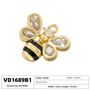 Macro detail of gold-plated brass bee pendant featuring sparkling cubic zirconia wings