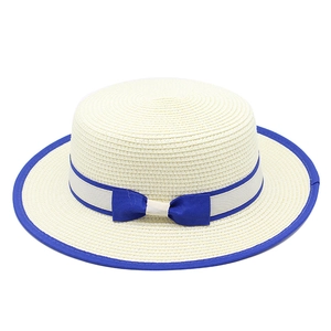 Women's straw boater sun hat with blue trim ribbon and bowknot on white background