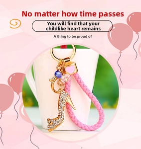 Close-up of sparkling rhinestone high heel keychain with pink braided leather strap