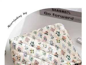 Macro detail of floral quilted cotton makeup bag showing stitch textures and tulip patterns
