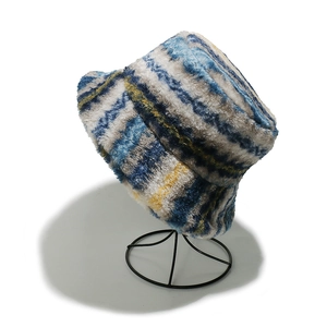 Close-up of thick plush bucket hat featuring blue and yellow gradient stripes texture