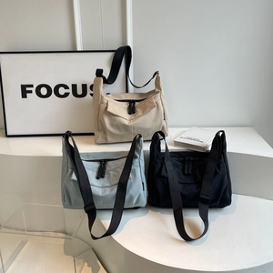 Minimalist canvas tote bag set in beige, light blue, and black with wide shoulder straps