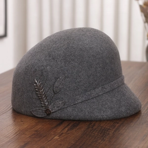 Detail of wool cloche hat featuring intricate beaded wheat and leaf embellishments