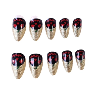 Halloween pumpkin pattern long almond press-on nails with black and gold glitter accents