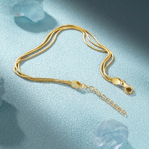 Detail of gold triple-layered snake chain bracelet with S925 hallmark and lobster clasp