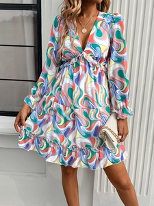 Detail of elegant V-neck dress with colorful abstract swirl print and layered ruffles