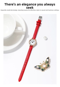 Close-up of elegant small round gold watch with red leather strap and roman numerals