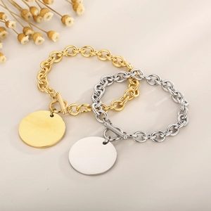 Detailed shot of gold and silver titanium steel OT buckle bracelets with round tags
