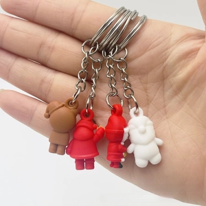 Close-up of colorful mini silicone Santa and cartoon bear keychains with silver rings
