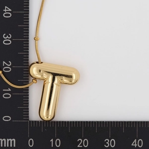 Detailed measurement of puffy gold balloon T-letter pendant on a scale showing 23mm size