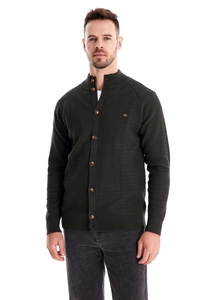 Detail of dark green knitted cardigan showing button closure and textured fabric