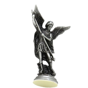 Vintage metal Archangel Michael statue holding spear and slaying dragon on white background