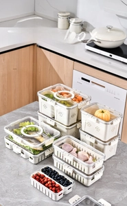 Detail of PET food storage boxes with drainage baskets for fridge organization