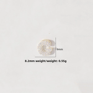 Detailed view of micro-pave zircon letter G charm in gold finish, size 9mm by 8.2mm