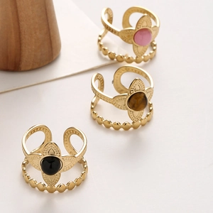 Detailed macro view of vintage double-layer floral rings with inset gemstone centers