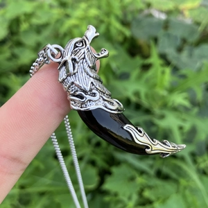 Vintage wolf head pendant with black talon on a silver chain for men’s cool style