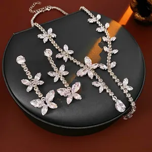 Elegant butterfly zircon necklace and earrings set on a black jewelry box display