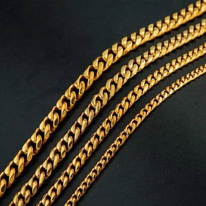Polished gold cuban link chains in four widths displayed on a black background