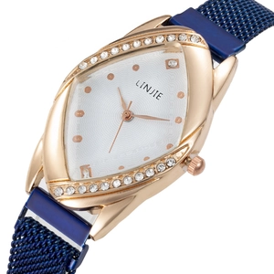 Detailed close-up of rose gold leaf-shaped watch case with sparkling crystal accents