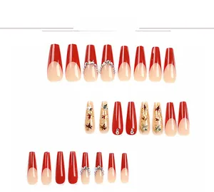 Detailed view of long coffin French press-on nails with autumn maple leaf and rhinestones