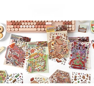 Detailed 2.5D isometric scenery stickers shown in a creative desk lifestyle setting