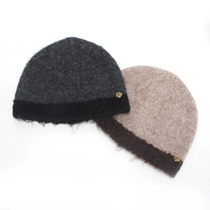 Detail of wool-blend knit bucket hats with fuzzy texture and golden rose metal accents