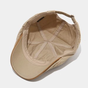 Beige cotton newsboy cap in vintage British style with adjustable metal buckle strap